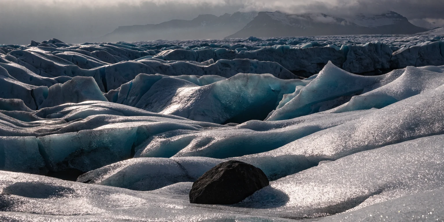 Glacial ice fragments stranded on black volcanic sand in Iceland